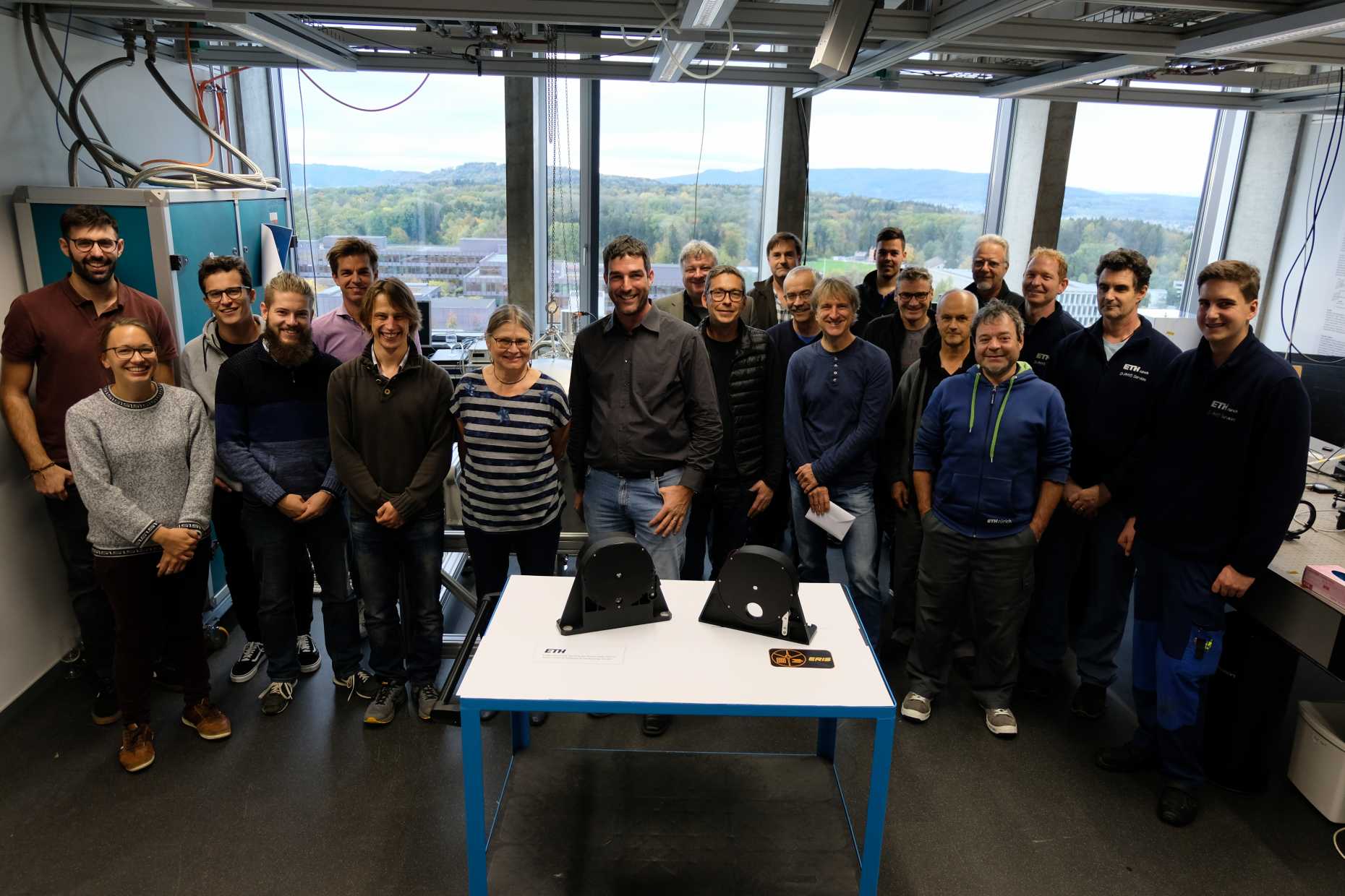 Enlarged view: The team that worked on the design, manufacturing and testing of the mechanisms, with the two finished wheels in the Laboratory for Astronomical Instrumentation at ETH.