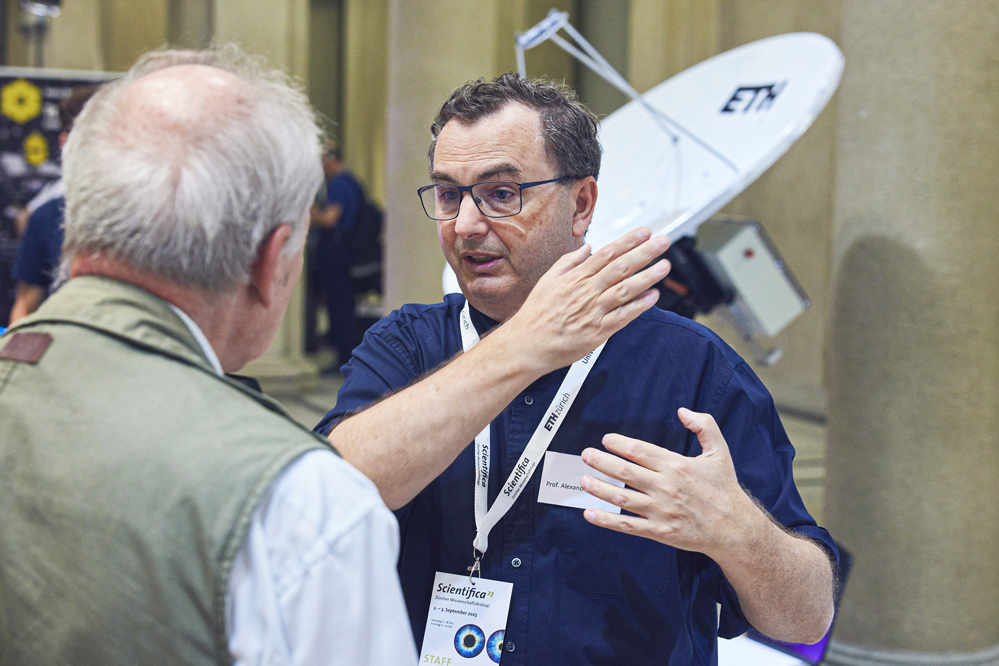 Alexandre Refregier in conversation with a visitor