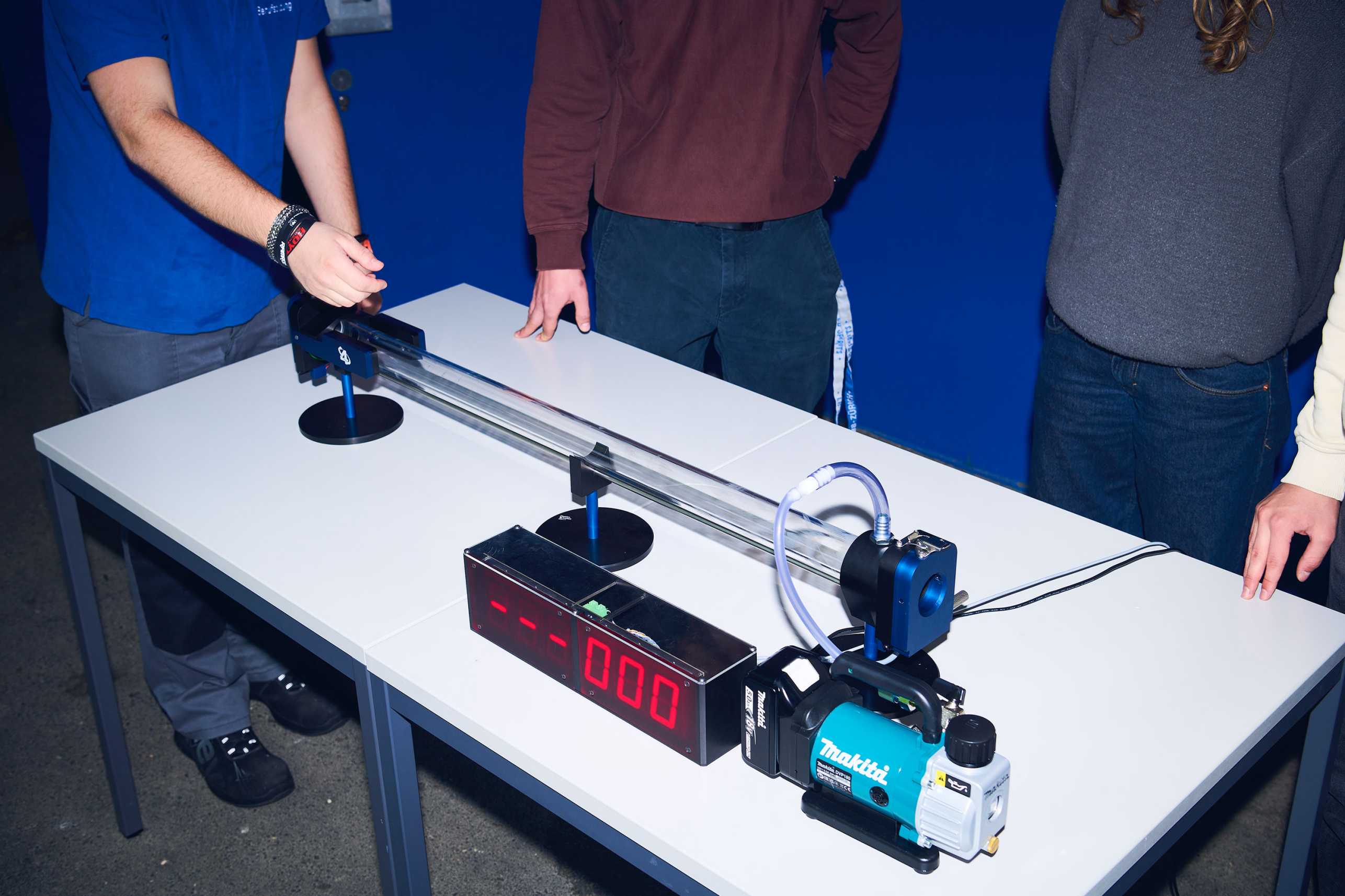 Four apprentices present the vacuum cannon they have built