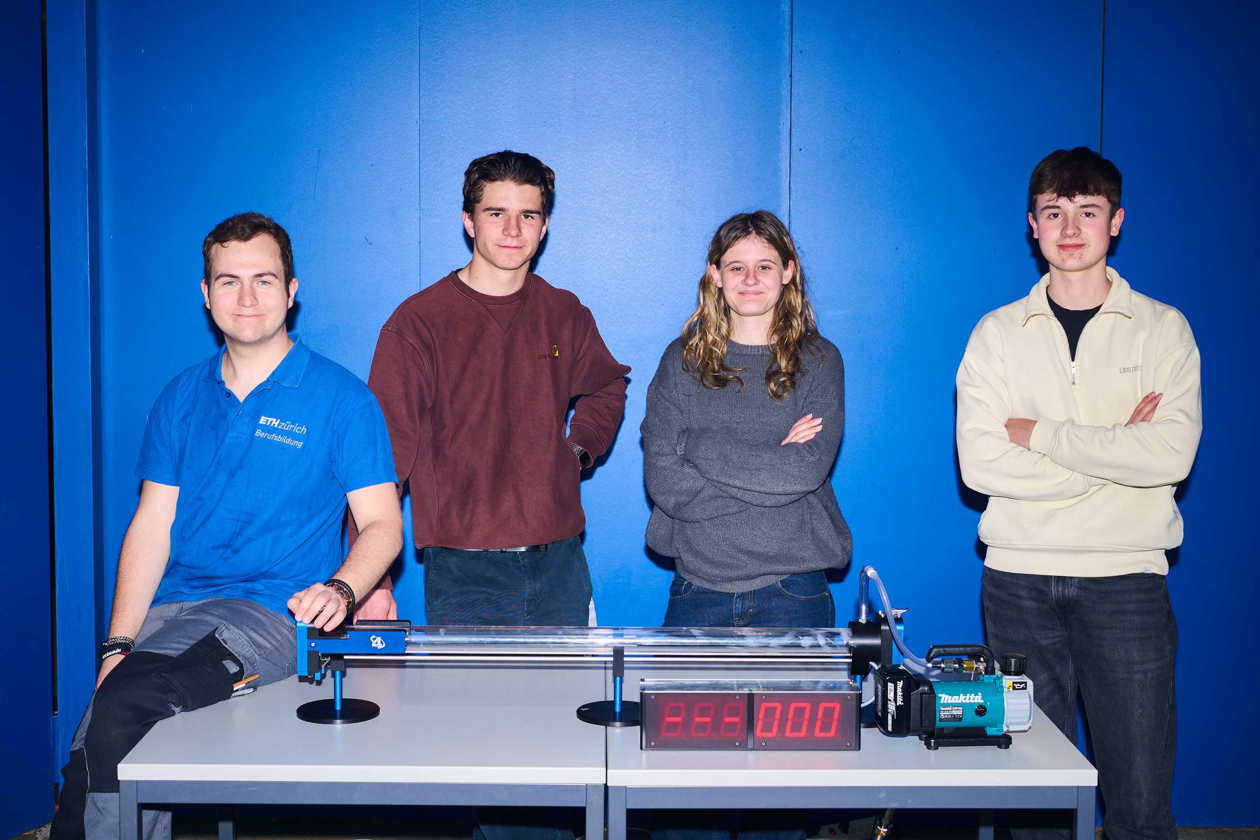 Four apprentices present the vacuum cannons they have built
